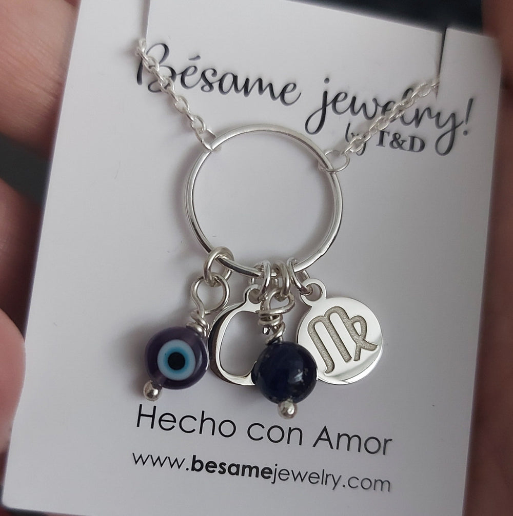 Collar inicial, signo, piedra y ojo
