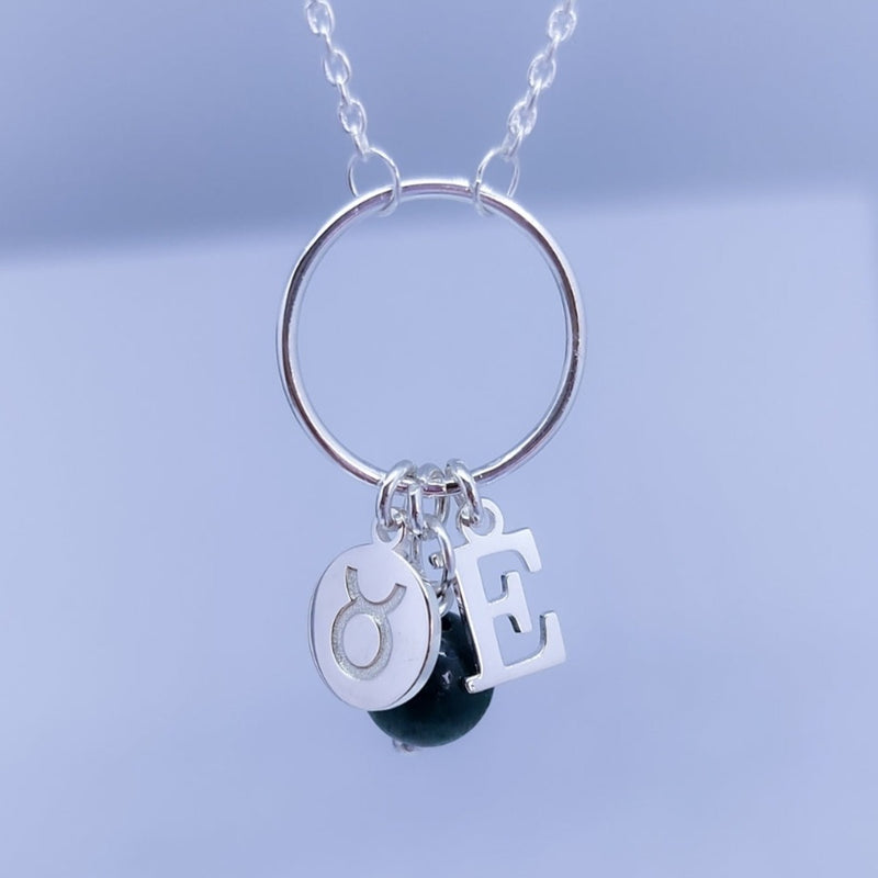 Collar inicial, signo, piedra y ojo